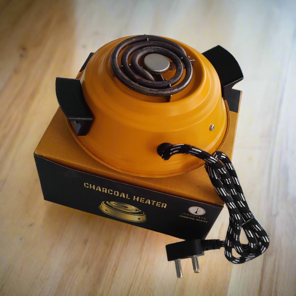 Cocoyaya 500-watt charcoal burner in yellow with a coiled heating element and a braided power cord, displayed on its packaging box, designed for heating hookah charcoal.